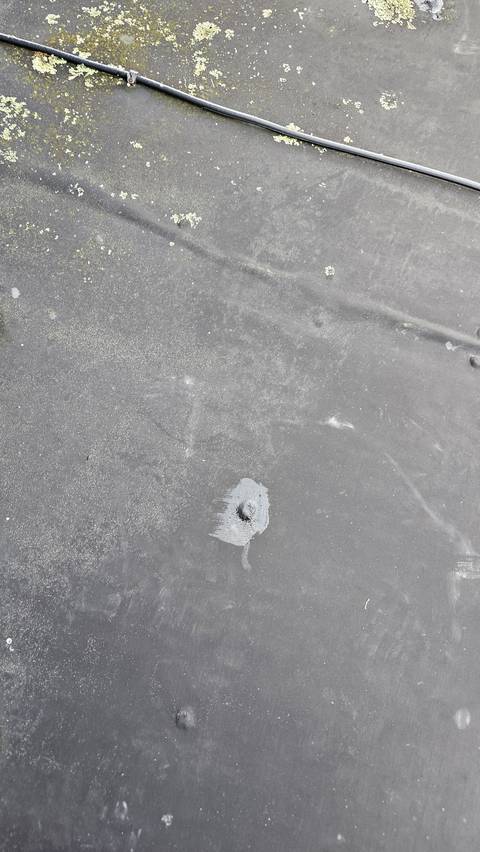 A small raised point has pushed up through this Butynol sheet, likely a fixing working its way through from below.